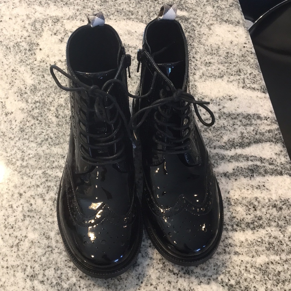 All black pat and leather Burberry flat boots.